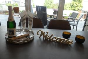 a table with a bottle of champagne and some cupcakes at Ferienwohnung Wolkenfeld in Kaisersesch