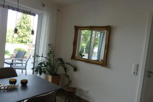 a room with a table and a mirror on the wall at Ferienwohnung Wolkenfeld in Kaisersesch