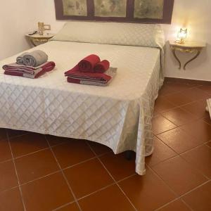 a white bed with towels and pillows on it at Casale Battaglini in Castelnuovo Cilento