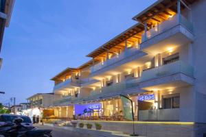 a building with a motorcycle parked in front of it at Grand TheoNi Boutique Hotel & Spa in Vasiliki