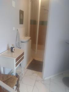 a bathroom with a sink and a toilet and a shower at Silver chambre in Creil