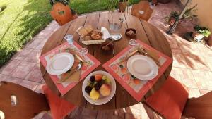 a wooden table with a plate of fruit on it at Casale Battaglini in Castelnuovo Cilento