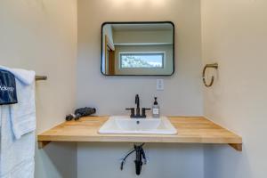 a bathroom with a sink and a mirror at Crooked River Ranch Cabins in Terrebonne +56 photos