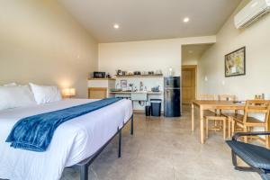 a bedroom with a bed and a table and a kitchen at Crooked River Ranch Cabins in Terrebonne