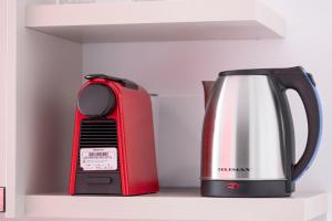 a redffeepot and a tea kettle on a shelf at Blue Horizon Sarti Chalkidiki in Sarti