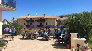 a group of people sitting at tables in front of a building at Hotel Cenzo in Ovindoli +23 photos