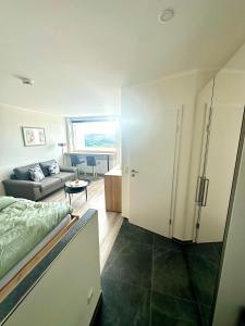 a bedroom with a bed and a living room at Wolkenparadies in Altenau