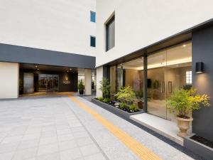 an office building with a courtyard with potted plants at SODO Hotel in P'aju