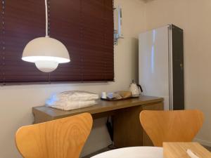 a kitchen with a table with two chairs and a refrigerator at SODO Hotel in P'aju