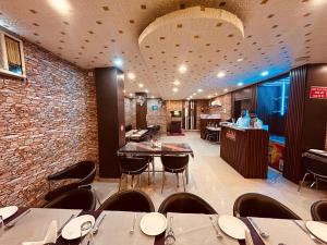 a restaurant with tables and chairs and a bar at Hotel Sky View in Aurangābād