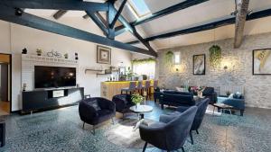 a large living room with couches and a tv at L'Escale des Alpilles in Rognonas