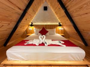 two people laying on a bed in a attic at Pahadi Sukoon - A frame Cottages in Dharamshala