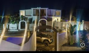 a car parked in front of a house at night at Kk resort sonkatch in Sonkach