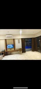a living room with a television and a chair at Kk resort sonkatch in Sonkach