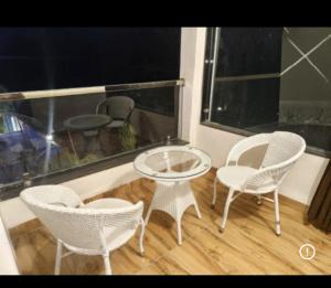 a group of chairs and a table on a balcony at Kk resort sonkatch in Sonkach