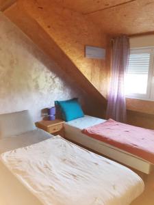 a bedroom with two beds and a window at Bien être la violette in Saint Malo