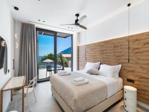 a bedroom with a large bed and a balcony at Eleage Villas in Lefkada +79 photos