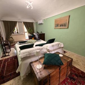 a large bedroom with two beds and a table at Oasi di pace in Romano Canavese