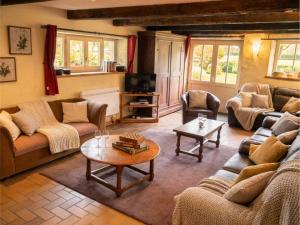 a living room with couches and a coffee table at Domaine de Marmonfosse in Taintrux