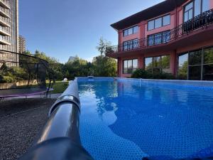 a swimming pool in front of a building at Glory Apart Hotel in Truskavets