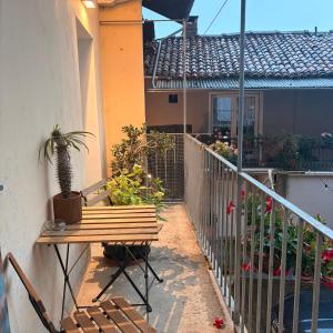 a patio with a bench and a table with a plant at Oasi di pace in Romano Canavese