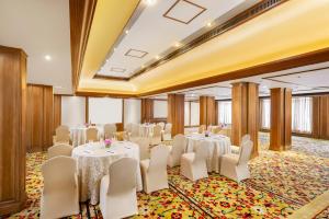 a banquet hall with white tables and white chairs at Tajview, Agra-IHCL SeleQtions in Agra +53 photos