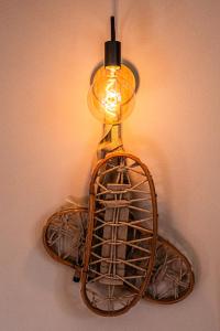 a light hanging on a wall with a bird cage at Chalet Meridiana in Bormio +68 photos