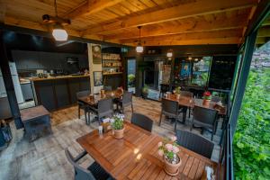 a restaurant with tables and chairs and a kitchen at Danzi camping tiny house in Kise