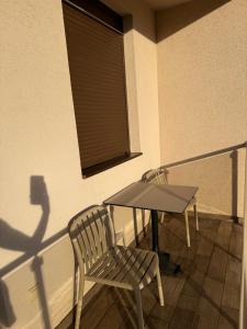 a balcony with a table and a bench and a window at Apartman ML Company in Bečići
