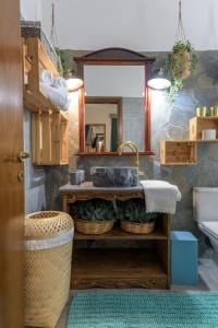 a bathroom with a sink and a mirror at Casa Dell Artista with private jacuzzi in Kos +27 photos