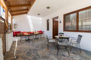 a dining room with tables and chairs in a room at Casa Dell Artista with private jacuzzi in Kos