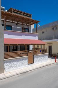 a building with a restaurant on the side of the street at Casa Dell Artista with private jacuzzi in Kos