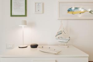 a white table with a lamp on top of it at Casa Bianca Rais Gerbi in Finale +90 photos