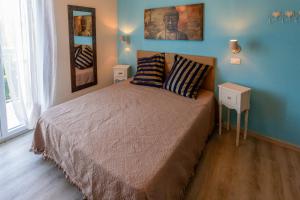 a bedroom with a bed with two pillows on it at B&B Santiago in Milano Marittima