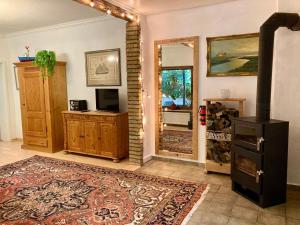 a living room with a large mirror and a rug at Kutscherwohnung in Kiel