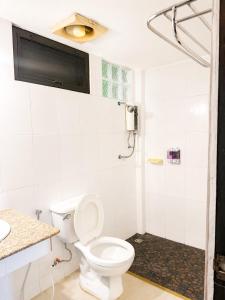 a white bathroom with a toilet and a shower at Baan Lanna ChiangRai in Chiang Rai +48 photos