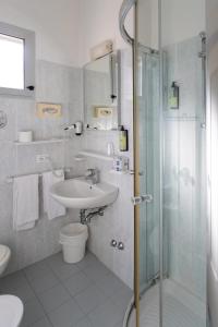 a bathroom with a shower and a sink and a toilet at B&B Santiago in Milano Marittima +27 photos
