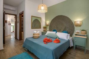 a bedroom with a bed with two red bows on it at Casa Dell Artista with private jacuzzi in Kos