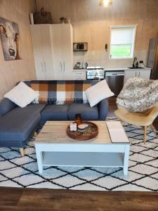 a living room with a couch and a coffee table at Warkworth Barn Retreat in Warkworth