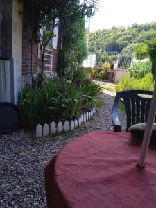 a red rug sitting on the ground next to a bench at Silver chambre in Creil