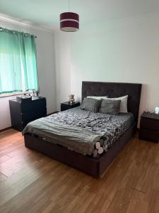 a bedroom with a large bed in a white room at Montejunto Escape in Cadaval