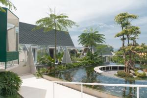 a house with a pond in front of a house at Suka Village 