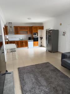 a kitchen and living room with a stainless steel refrigerator at Montejunto Escape in Cadaval