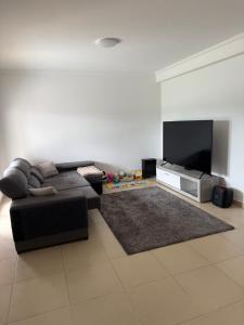 a living room with a couch and a flat screen tv at Montejunto Escape in Cadaval