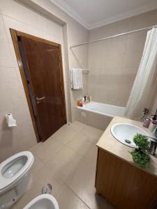 a bathroom with a toilet and a sink and a tub at Montejunto Escape in Cadaval +6 photos