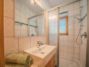 a bathroom with a sink and a shower at Appartements Gamper - Alpline Appartements KG in Brixen im Thale