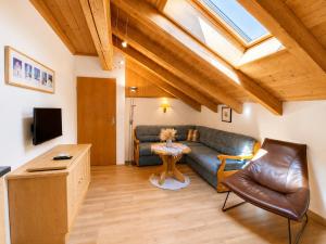a living room with a couch and a table at Resort Amadeus-Landhaus Amadeus in Gröbming