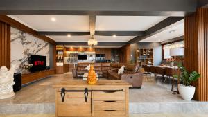 a living room with a couch and a table at Mountain Healing Villa by Nagisa Bali in Baturiti