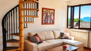 a living room with a couch and a spiral staircase at Residenza Paradiso in Agra