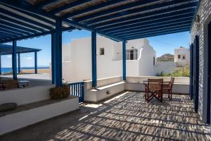 a patio with a table and chairs on a house at Almira Studios in Kionia